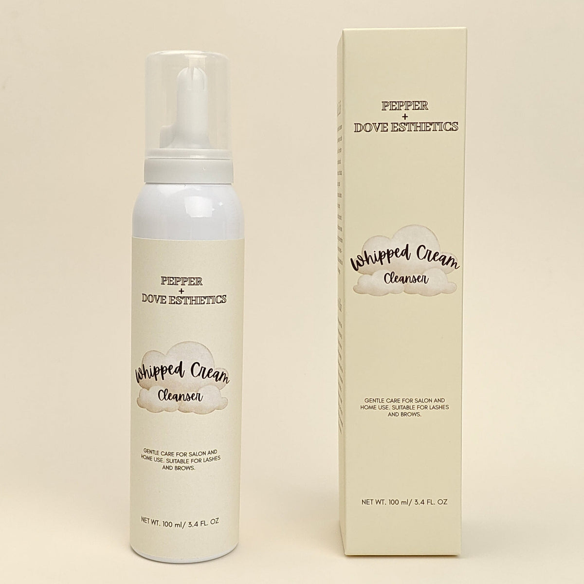 A white bottle of Pepper Dove Botanicals Whipped Clean Cleanser stands next to its cream-colored rectangular box on a warm beige background.
